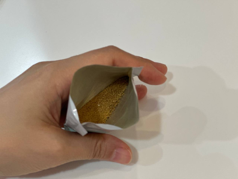손이 열린 파우치를 들고 있으며, 파우치 안에 갈색 가루가 담겨 있습니다 — 서울 바로한의원 초음파 약침·도침